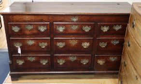 An 18th century oak and mahogany cross-banded chest, having hinged lid and six dummy drawers above