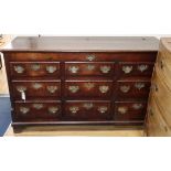 An 18th century oak and mahogany cross-banded chest, having hinged lid and six dummy drawers above