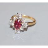 An 18ct yellow metal, single stone ruby and graduated eight stone diamond cluster ring, size M.