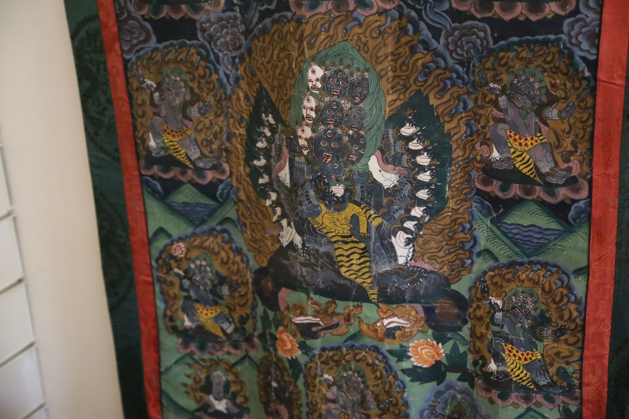 A thangka depicting a Buddhist wrathful deity, Tibet, first half 20th century, surrounded other - Image 3 of 3
