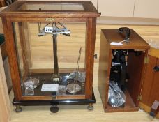 A set of balance scales and a cased "Beck" microscope