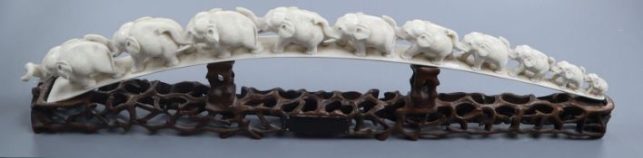 A Chinese carved ivory ten-elephant bridge on pierced carved hardwood stand, bearing presentation