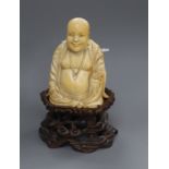 A Chinese ivory figure of a Budai, on stand H.13cm