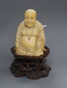 A Chinese ivory figure of a Budai, on stand H.13cm