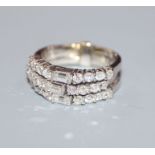 A white metal, baguette and round cut diamond set triple band ring, size