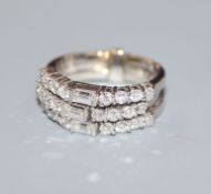 A white metal, baguette and round cut diamond set triple band ring, size