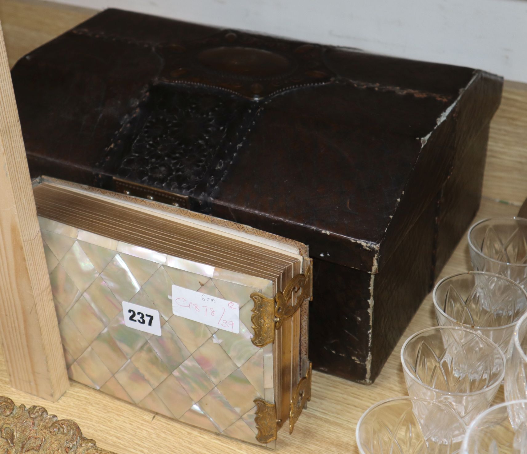 A Victorian mother of pearl photograph album and a leather mounted casket