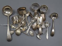 A small group of silver/white metal comprising four spoons, two ladles, four serviette rings,