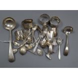 A small group of silver/white metal comprising four spoons, two ladles, four serviette rings,