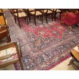 A North West Persian design crimson ground carpet 426 x 310cm