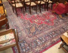 A North West Persian design crimson ground carpet 426 x 310cm