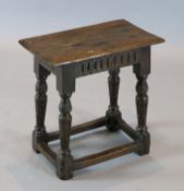 A James I oak joint stool, with lunette carved frieze, carved and fluted legs and all-round
