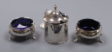 A George III silver drum mustard, London, 1792 and a pair of earlier silver bun salts.