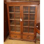 A Continental glazed teak two drawer bookcase W.102cm