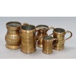 Five 19th century bell metal mugs height 17cm