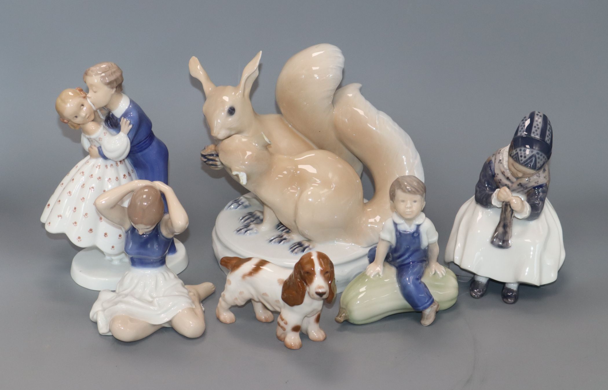 Four Royal Copenhagen figures, a dog and squirrel group tallest 19cm