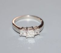 A platinum and graduated three stone princess cut diamond ring, total approximate carat weight 1.