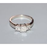 A platinum and graduated three stone princess cut diamond ring, total approximate carat weight 1.