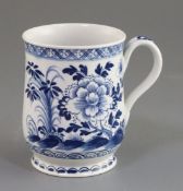 A Bow bell-shaped blue and white mug, c.1770 painted with flowers rockwork and insects, unmarked, H.