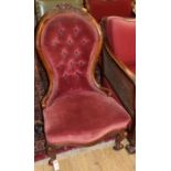 A Victorian walnut spoonback nursing chair