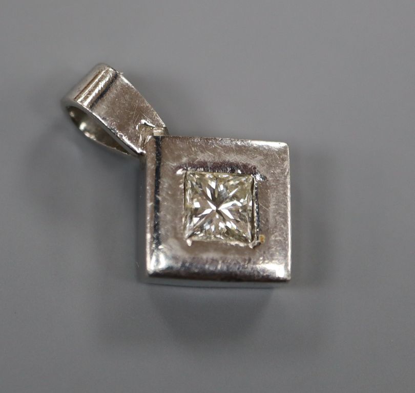 A white metal (stamped plat) and princess cut diamond set pendant, overall 18mm.
