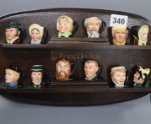 Twelve Royal Doulton Dickens miniature character jugs with Doulton display shelf