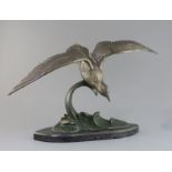 Irene Rochard. An Art Deco bronze model of a seagull flying above waves, signed in the bronze, on
