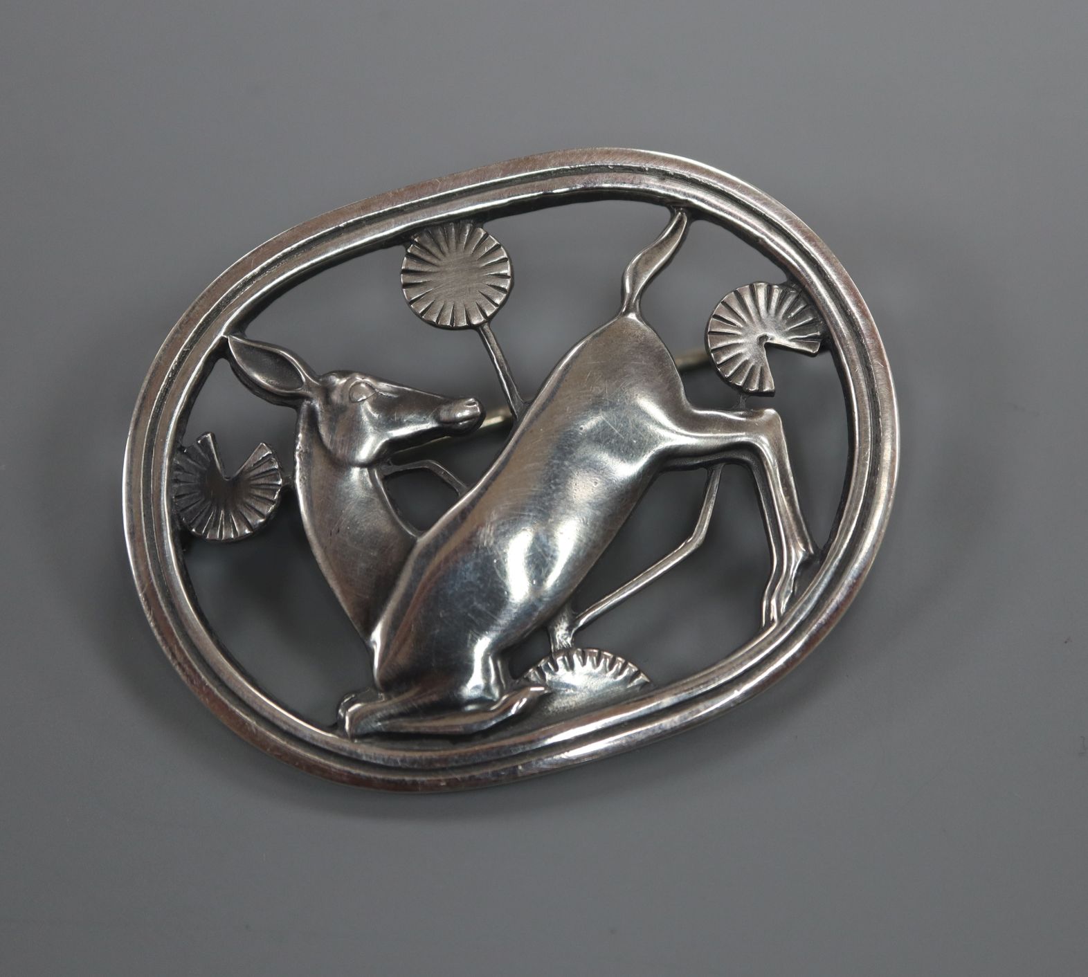 A Danish Georg Jensen sterling 'kneeling deer' oval brooch, no. 256, 43mm.