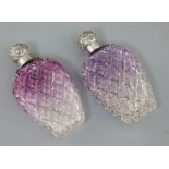 A pair of late Victorian silver lidded amethyst tinted cut glass scent flasks, of baluster form, C.