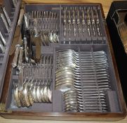 A plated service of flatware in oak canteen