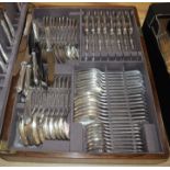 A plated service of flatware in oak canteen