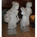 A pair of reconstituted stone garden figures tallest 77cm