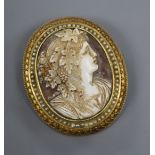 A yellow metal (tests as 18ct) and seed pearl mounted oval cameo brooch, carved with the bust of a