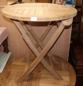 A circular teak circular folding garden table Diam. 70cm