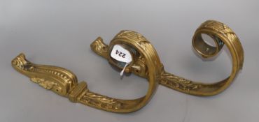 A pair of Empire style gilt metal curtain pole brackets length 35cm