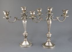 A pair of American Gorham sterling silver, two branch, three light candelabra, decorated with scroll