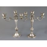 A pair of American Gorham sterling silver, two branch, three light candelabra, decorated with scroll