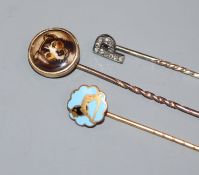 An early 20th century diamond set 'initial' stick pin and two other stick pins.