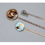An early 20th century diamond set 'initial' stick pin and two other stick pins.