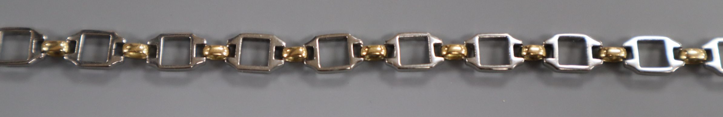 A Cartier steel and yellow metal bracelet with box and certificate, (later replaced 9ct clasp),