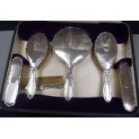 A cased George V engine turned silver six piece dressing table set.
