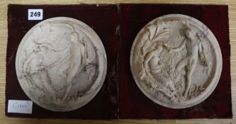 A pair of circular alabaster plaques