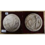 A pair of circular alabaster plaques