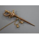 A yellow metal and gem set jabot? pin, modelled as a sword with scabbard, 71mm.
