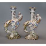 A pair of French faience pottery armorial candlesticks H.26cm