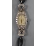 A lady's P. Buhre white metal (stamped All Plat) and diamond set cocktail watch, with fabric strap.