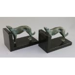 Constant Roux. A pair of bronze and black marble bookends, modelled with standing borzoi, 7in.