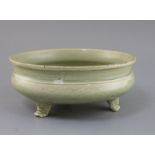 A Chinese Ming Longquan celadon tripod censer, 16th century, the exterior incised with foliage, on