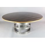 A contemporary macassar ebony veneered circular dining table, with brushed steel strapwork drum