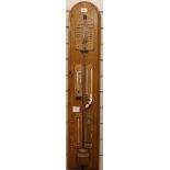 An oak barometer by S & B Solomon, 39 Albemarle Street, London, fitted four thermometers and storm